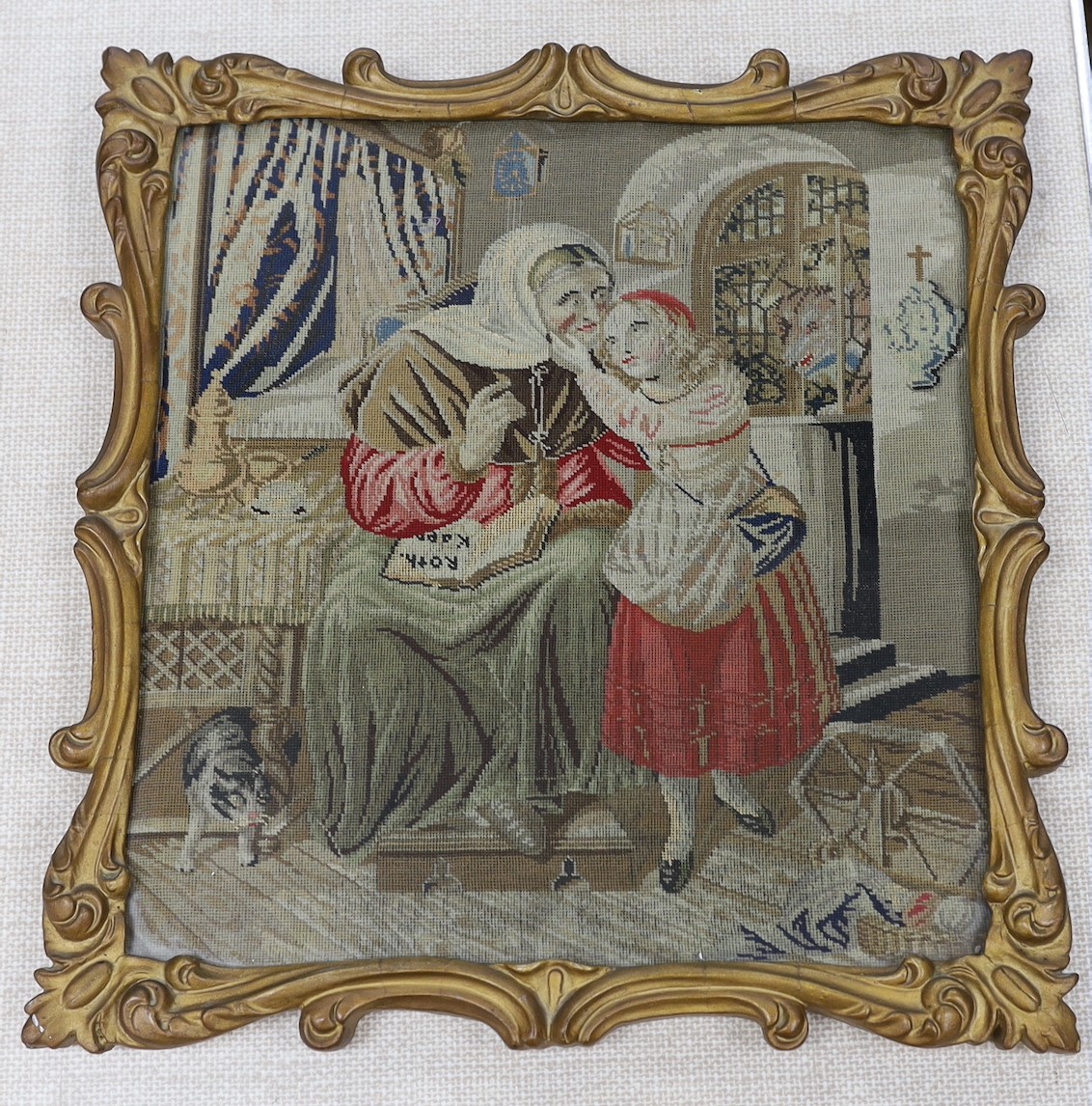 A 19th century gilt-framed petit point figural interior scene, 35 cms wide x 37 high.